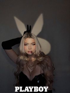 a woman with long blonde hair wearing bunny ears