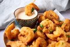 fried food on a plate with dipping sauce