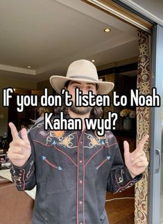 a man wearing a cowboy hat gives the thumbs up while standing in front of a glass door