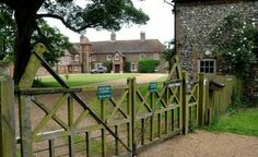 an old brick building with a gate in front of it