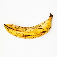 a ripe banana sitting on top of a white table