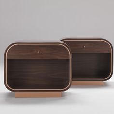 two wooden trays sitting on top of each other