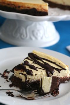 a slice of cheesecake on a plate with chocolate sauce and ice cream drizzle