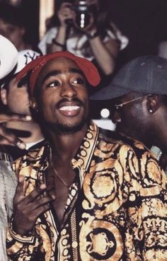 a man wearing a red hat and gold shirt