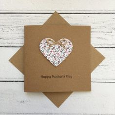 a mother's day card with a heart shaped brooch attached to the front