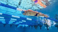 a man swimming under water in a pool