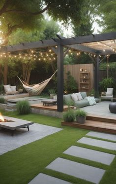 an outdoor living area with seating, fire pit and hammock