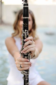 a woman holding a flute in her hands