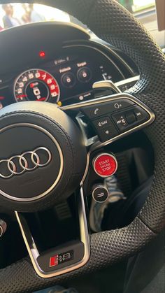 the steering wheel and dashboard of an audi car