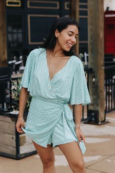 Short sleeve V-neck, wrap bottom romper. Rebeka is wearing a size smallLightweight Lined﻿Size Chart:Small: Waist: 26 in. Hips: 38 in.Medium: Waist: 28 in. Hips: 40 in. Large: Waist: 30 in. Hips: 42 in.HEY BABE! WE ONLY OFFER STORE CREDIT FOR RETURNS! Feel free to email us or DM us on Instagram with any questions regarding fit or sizing or our return policy in general. Summer V-neck Wrap Dress For Brunch, Summer Wrap Dress With Tie Waist And Surplice Neckline, Summer Vacation Jumpsuits And Rompers With Surplice Neckline, Beach Jumpsuits And Rompers With Surplice Neckline For Spring, Summer Vacation Jumpsuits With Surplice Neckline, Spring Beach Jumpsuits With Surplice Neckline, Summer Wrap Dress For Day Out, Wrap Dress For Day Out, V-neck Wrap Dress With Tie Waist For Day Out