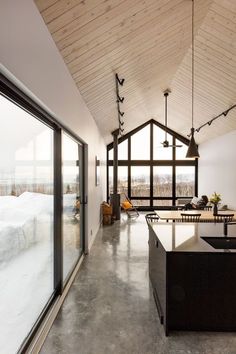 an open kitchen and living room with sliding glass doors