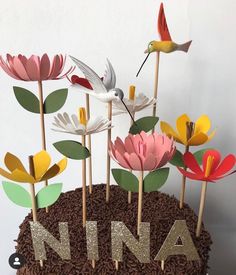 a cake decorated with flowers and birds on it's top is the word ninja