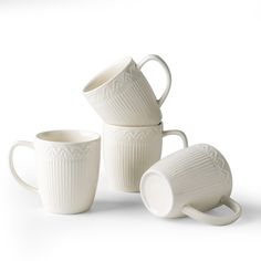 three white mugs sitting next to each other