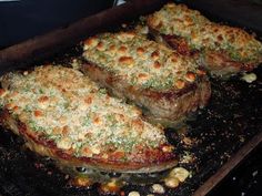 three steaks cooking in an oven with some seasoning on them and other toppings