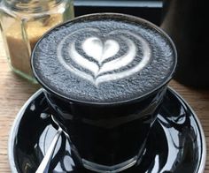 a cappuccino on a saucer with a spoon