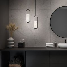 a bathroom with two sinks and three hanging lights