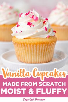 vanilla cupcakes with white frosting and sprinkles are on a plate