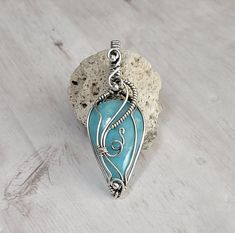 Teardrop hemimorphite gemstone wrapped in oxidized sterling silver with sterling silver beads. Pendant comes with 20'' matching stainless steel chain. Wire Wrapped Turquoise Pendant Necklace, Artisan Silver Turquoise Wire Wrapped Necklace, Beads Pendant, Oxidized Sterling Silver, Sterling Silver Bead, Steel Chain, Stainless Steel Chain, Silver Beads, Pendant Necklaces