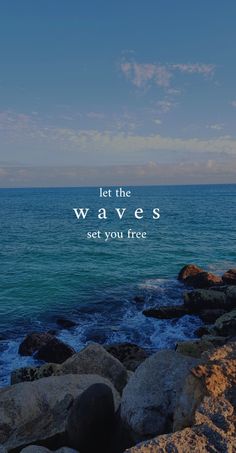 the ocean with rocks and blue sky above it that says, let the waves set you free