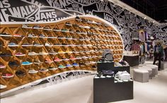 the inside of a shoe store with lots of shoes on display