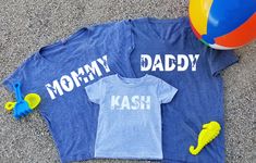 This listing is for two super soft comfy shirts with Mommy and Daddy shark designs and one short sleeve kids T-shirt with a custom personalized name design on it with sharks .  The Womens shirt is available in a dolman style as pictured, crew neck t-shirt or vneck t-shirt.  The Mens shirt is available in a vneck, as pictured or crew neck. Available colors: Black White Charcoal Heather Gray Navy Military Green Pink Red Royal Blue Baby blue Turquiose Mint These tops are true to sizing. Please also Playful Blue Tops With Name Print, Customizable Blue Tops For Family Occasions, Fun Blue Tops With Name Print, Fun Blue Top With Name Print, Mommy Shark, Baby Shark Birthday, Mommy And Me Shirts, Mommy And Me Shirt, Navy Military