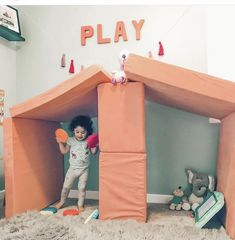 a child playing in a play house made out of foam