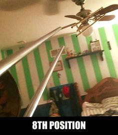 a ceiling fan is hanging from the ceiling in a room with green and white striped walls