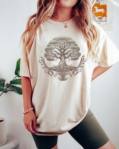 Introducing our ethereal Tree of Life Comfort Colors Shirt, a blend of enchanting design and unmatched comfort. Crafted with 100% ring-spun cotton, this shirt offers a luxurious softness and breathability that keeps you feeling cozy all day. The centerpiece of this captivating tee is the sepia-toned Tree of Life design, exuding a mystical and ethereal aura. Symbolizing interconnectedness and growth, the intricate depiction adds a touch of nature-inspired beauty to your wardrobe. Made with a soft-washed, garment-dyed fabric, this shirt takes comfort to the next level. The material has been carefully treated to provide extra coziness, making it feel like a cherished favorite from the moment you put it on. Its relaxed fit ensures a comfortable and laid-back vibe, making it an excellent choice Nature-inspired Relaxed Fit Short Sleeve T-shirt, Relaxed Fit Nature-inspired Short Sleeve T-shirt, Nature-inspired Relaxed Fit Short Sleeve Tops, Tree Of, Tree Of Life Design, Spiritual Shirts, Pretty Shirts, Floral Tee, Comfort Colors Shirt