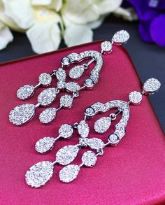 HANDCRAFTED TO PERFECTION! SPECIAL AND LOVELY FLORAL DESIGN, ILLUSION SETTING (APPEARS TO BE LIKE A 0.5-1.0 CARAT BRILLIANT PEAR Diamonds). With over 128 pieces of UNTREATED AND GENUINE F/VS QUALITY SPARKLING DIAMONDS! Perfect for every event! SET IN 18K SOLID WHITE GOLD HANDCRAFTED, CHANDELIER EARRINGS! SUGGESTED RETAIL VALUE: $11,000 DIAMONDS: 254 ROUND BRILLIANT, FULL CUT with excellent firing diamonds, weighting at 3.50 carats. ALL NATURAL, UNTREATED DIAMONDS. ALL DIAMONDS HAVE NO VISIBLE IN Fine Jewelry Teardrop Chandelier Earrings For Wedding, Teardrop Chandelier Earrings For Wedding, Luxury Diamond Earrings For Wedding With Sparkling Stones, Luxury Wedding Diamond Earrings With Sparkling Stones, Luxury Bridal Drop Earrings With Sparkling Stones, Wedding Fine Jewelry Chandelier Drop Earrings, Luxury Teardrop Chandelier Earrings With Cubic Zirconia, Luxury Bridal Dangle Earrings With Sparkling Stones, White Gold Drop Chandelier Earrings For Evening