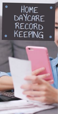 a woman sitting at a table with a laptop and cell phone in front of her