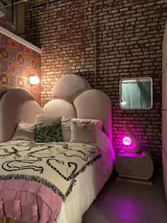 a bedroom with brick walls and a bed in the middle, illuminated by purple lights