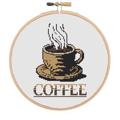 a cross stitch coffee mug with steam coming out of it and the words coffee on it