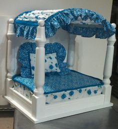 a white bed with blue flowers on it