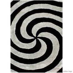 a black and white rug with an abstract swirl design on the center, in front of a