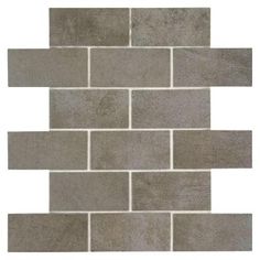 a gray brick wall that is made out of grey bricks and has white grouting