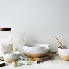 bowls and utensils are sitting on the counter