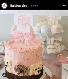 there is a pink cake with dogs on it