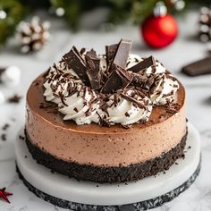 a chocolate cake with whipped cream and chocolate shavings