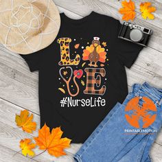 a t - shirt with the words love nurse life on it next to fall leaves