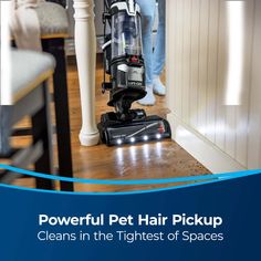 a person standing next to a table with a vacuum on it and the words powerful pet hair pickup cleans in the highest of spaces