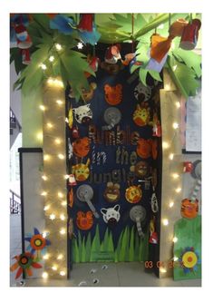 a door decorated for halloween with lights and decorations on the front, behind it is a jungle theme