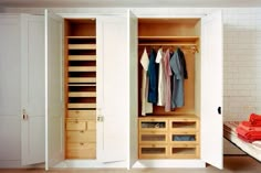 an open closet with clothes hanging in it