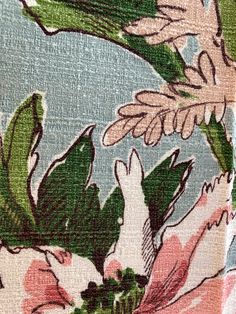 an image of a floral print fabric with green leaves and pink flowers on blue background