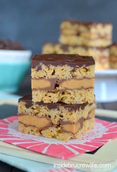 three pieces of chocolate peanut butter bars stacked on top of each other