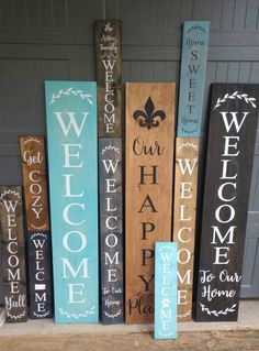 several wooden signs with the words welcome to our home and fleur de lis on them