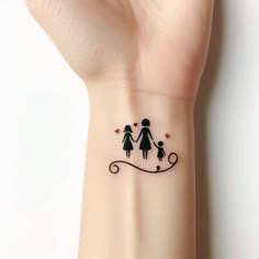 a small tattoo on the wrist of a woman's arm with an image of two people holding hands