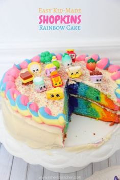 a rainbow cake is cut into pieces on a plate