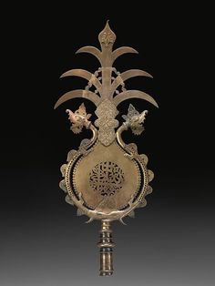 an ornate metal object with birds on it