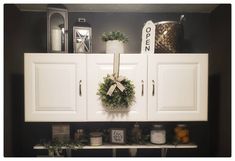 a wreath is hanging on the cabinet doors