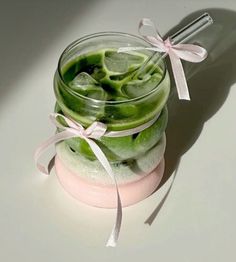 a jar filled with green and pink liquid